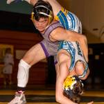 Jakob Dailey, left, flips Mariners Payton Britton.(Photo by John Fisken)