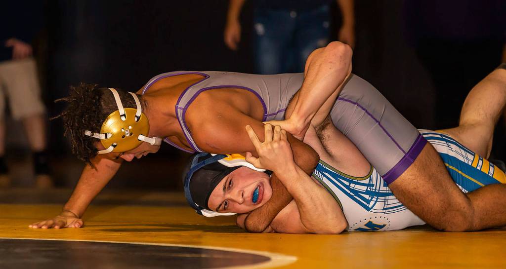 Brandon Liberty, top, tries to turn Mariners Spencer Sliss. (Photo by John Fisken)