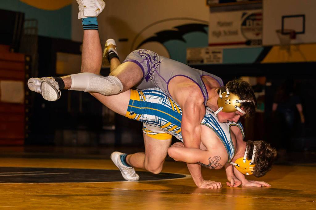 Blake McBride, top, goes for a ride with Mariners Ryan Fry.(Photo by John Fisken)