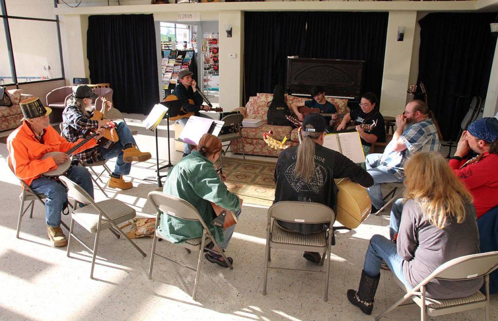 The Johnson family participates in a weekly acoustic jam session at Click Music in Oak Harbor.                                 (Photo by Maria Matson/ Whidbey News-Times)