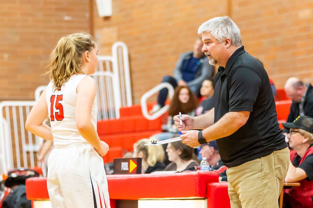 Coach David King, right, describes a change for Tia Wurzrainer.(Photo by John Fisken)