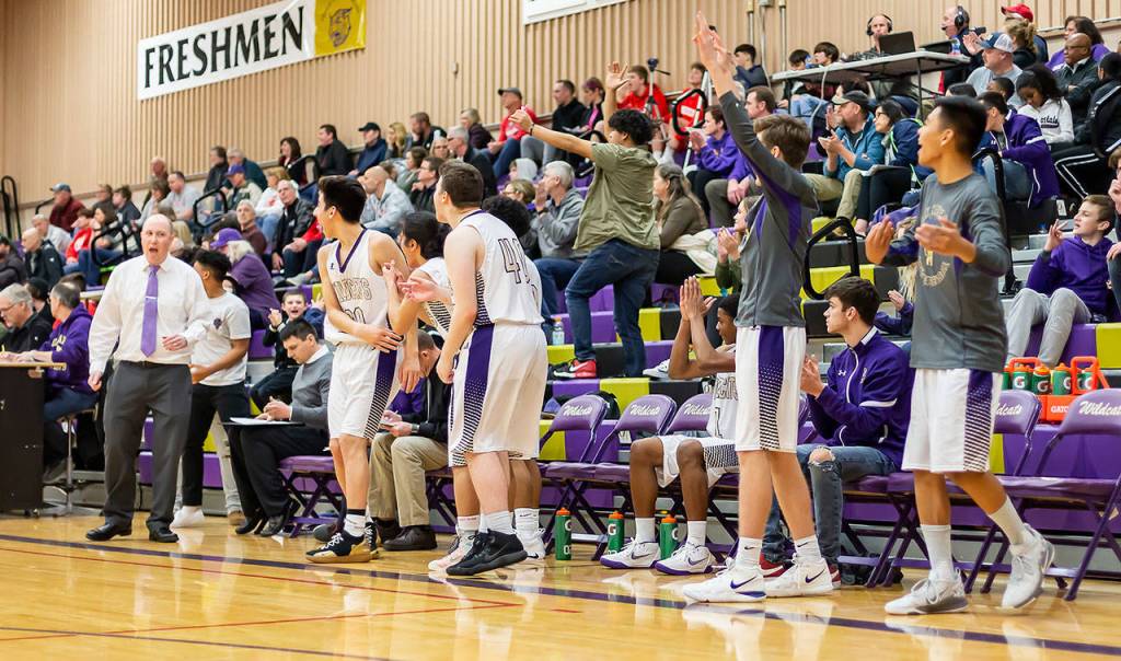 The Oak Harbor bench celebrates a nice play by their teammates on the court.(Photo by John Fisken)