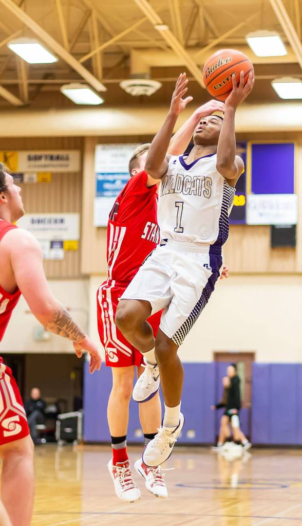 Dorian Hardin is fouled on the way to the hoop.(Photo by John Fisken)