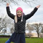 Katrin Kurganov shows off her popsicle stick on her away around the path. Photo by Laura Guido/Whidbey News-Times