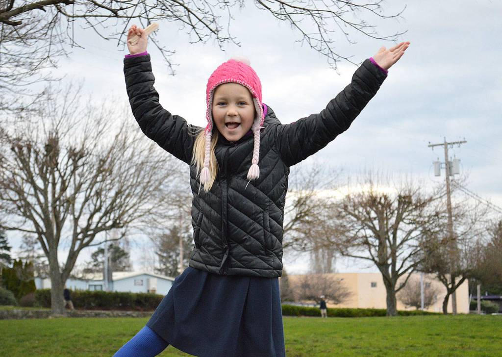 Katrin Kurganov shows off her popsicle stick on her away around the path. Photo by Laura Guido/Whidbey News-Times