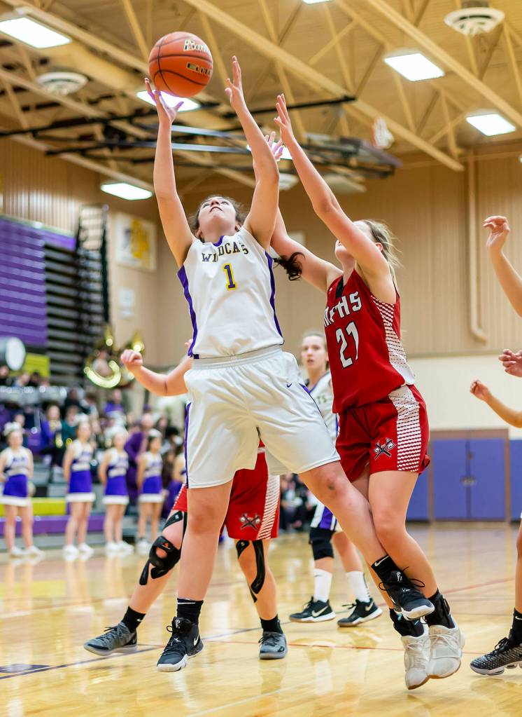 Anna Jones snags a rebound for Oak Harbor.(Photo by John Fisken)