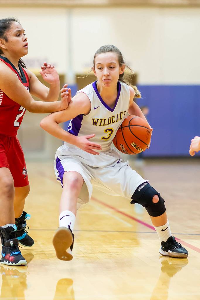 Miranda Wilson tries to shuffle by an M-P defender.(Photo by John Fisken)
