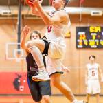 Sean Toomey-Stout explodes to the basket for the Wolves.(Photo by John Fisken)