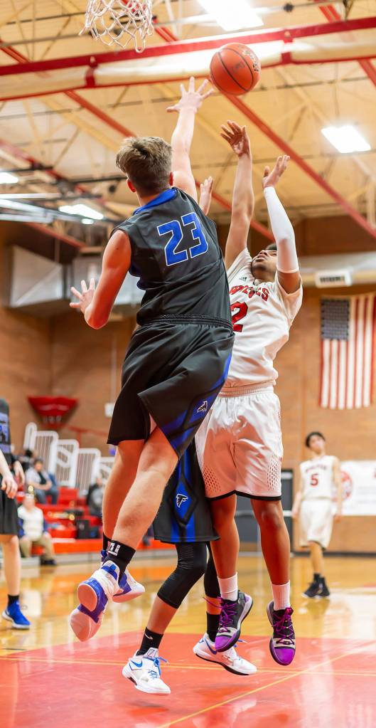 Coupeville Jakobi Pilgrim shoots over the defense of South Whidbeys Kole Nelson (23).(Photo by John Fisken)