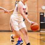 Hannah Davidson splits two Falcon defenders with the dribble.(Photo by John Fisken)