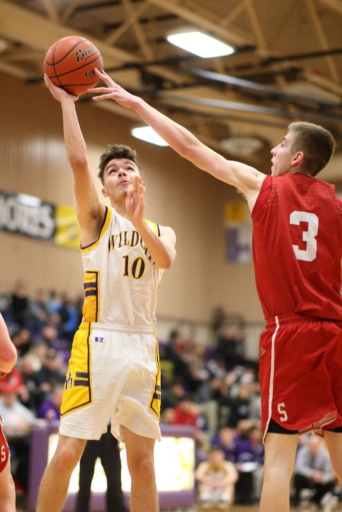 Rylee Simmons, left, slips the ball past Snohomishs Kolton Smith.(Photo by John Fisken)