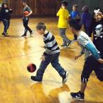 Cameron Devenport dribbles on the large gymnasium floor of the Roller Barn. Oak Harbor Boys & Girls Club members are all clustered in one area for the most part because of the buildings layout. The club hopes to sell the 107-year-old building to someone or a group who will preserve it. Photo by Laura Guido/Whidbey News-Times