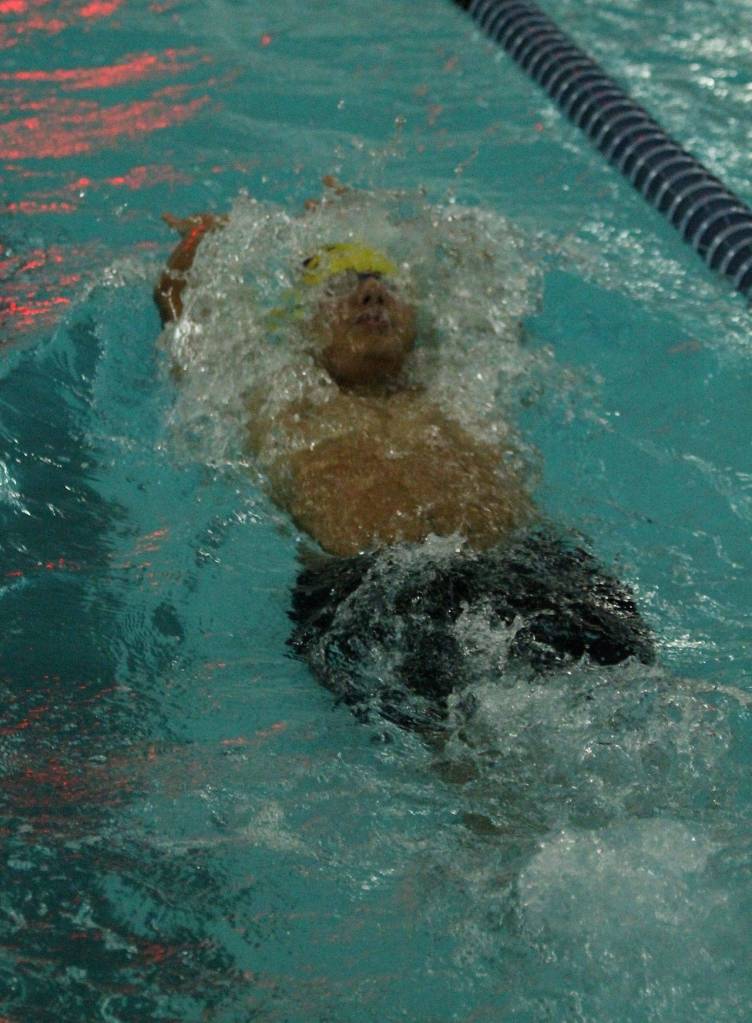 Aaron Martinez begins to surface after a turn in his winning effort in the 100-meter backstroke.(Photo by Jim Waller/Whidbey News-Times)