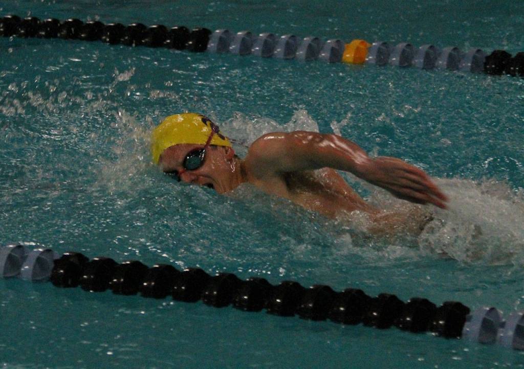 Riley Pickett swims the opening leg for Oak Harbors victorious 200-medley relay team. (Photo by Jim Waller/Whidbey News-Times)