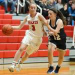Chelsea Prescott slips by the defense of Cedar Park Christians Abby Perrigoue.(Photo by John Fisken)