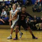 Coupevilles Jakobi Pilgrim (2) blocks out South Whidbeys Kody Newman on a free throw. (Photo by Jim Waller/Whidbey News-Times)