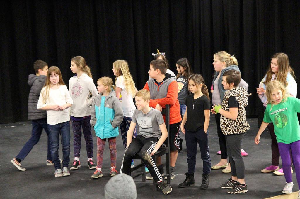 President Roosevelt, in chair, played by Chase Anderson, shows up to report that Annies parents have died and imposters were trying to adopt her for the money. n