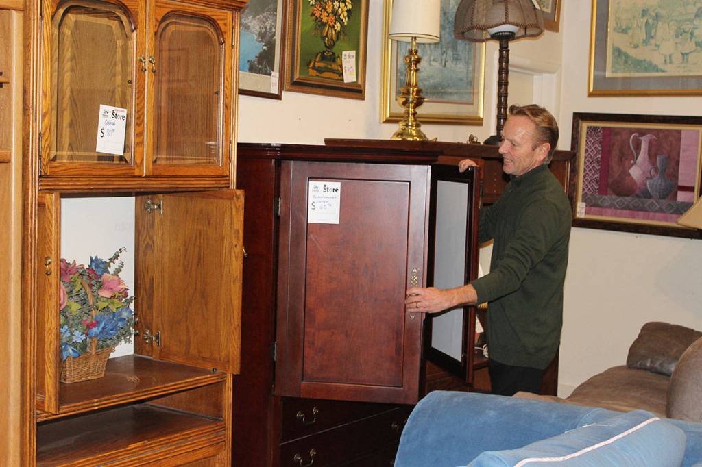 Store Director Tony Persson, new store director, looks over cabinets at the Oak Harbor Habitat for Humanity of Island County store. The organization is revamping its stores, image and community reach.