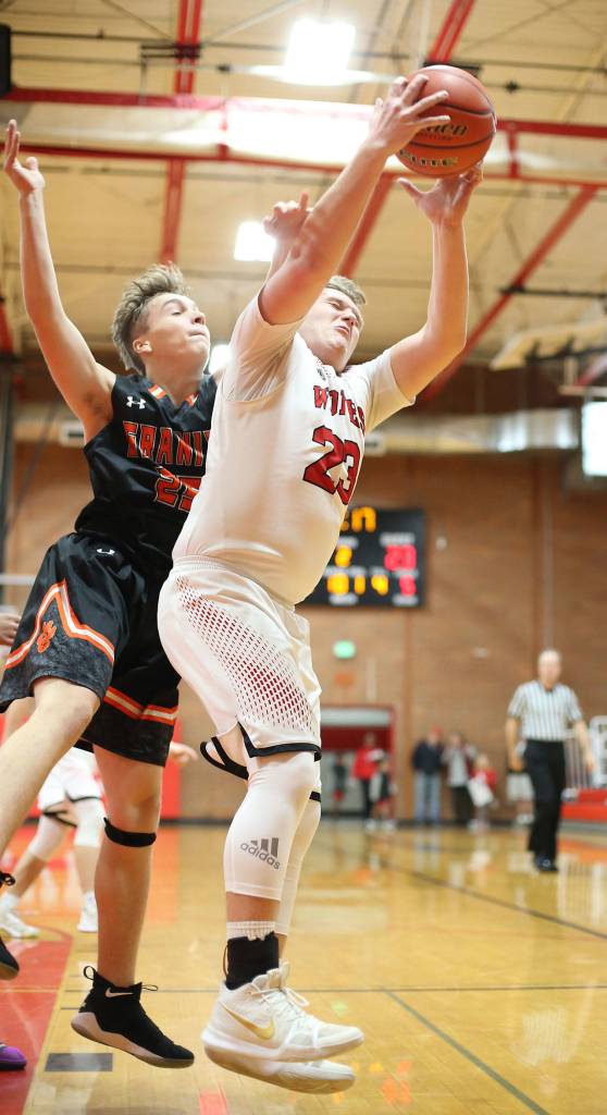 Coupevilles Dane Lucero, right, hauls in a rebound.(Photo by John Fisken)