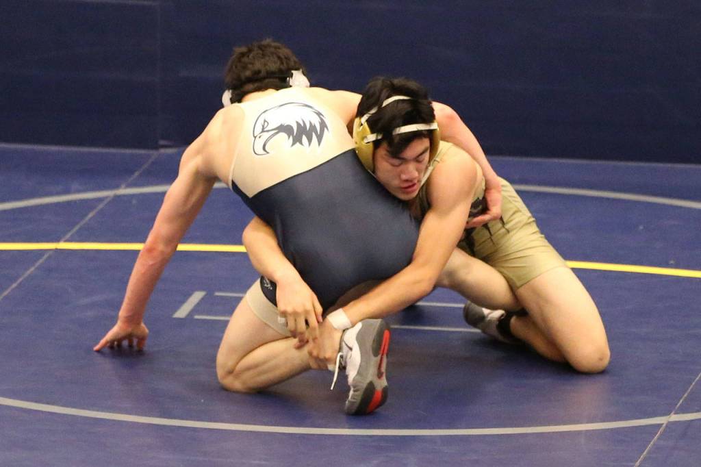 Oak Harbors Jakob Daily, right, defeats Todd Smith of Arlington.(Photo by John Fisken)