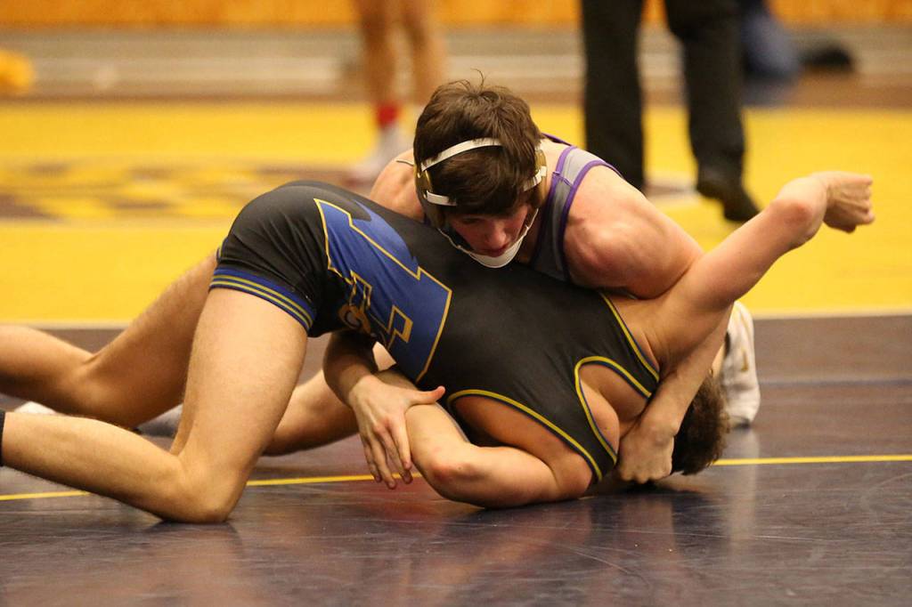 Oak Harbors Blake McBride, top, turns Ferndales Fischer Drury.(Photo by John Fisken)
