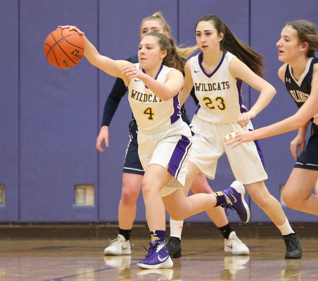 Oak Harbors Sami Olson (4) runs down a loose ball while Emily Gouge (23) looks on.(Photo by John Fisken)