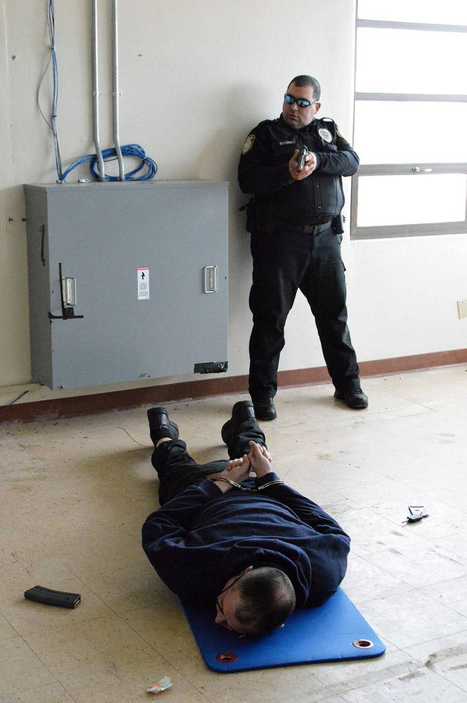 Department of the Navy Officer Cory Becherer keeps an eye on the perpetrator, Master at Arms Chief Anthony Silva, in an active shooter training drill Thursday. Photo by Laura Guido/Whidbey News-Times