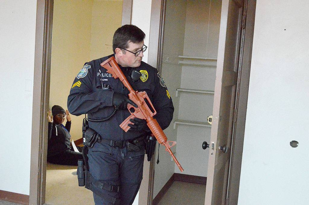 Officer Tony Slowik, Oak Harbor Police Department, performs a sweep Thursday during an active shooter scenario held at the Sea Plan Base. Local law enforcement joined the Navy in its annual Citadel Shield-Solid Curtain training exercises. Photo by Laura Guido/Whidbey News-Times