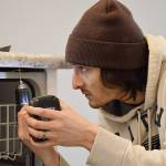 Ian Miranda installs a dishwasher in a newly built home in Coupeville. The town council voted to significantly lower fees, which were much higher than in nearby jurisdictions. (Photo by Laura Guido/Whidbey News-Times)