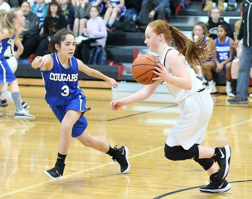 Maddie Georges, right, tries to beat a South Whidbey defender.(Photo by John Fisken)