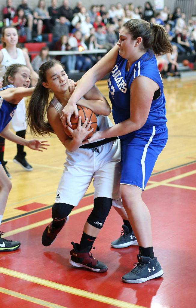Coupevilles Nezi Keiper, left, battles for control with South Whidbeys Morgan Batchelor.(Photo by John Fisken)
