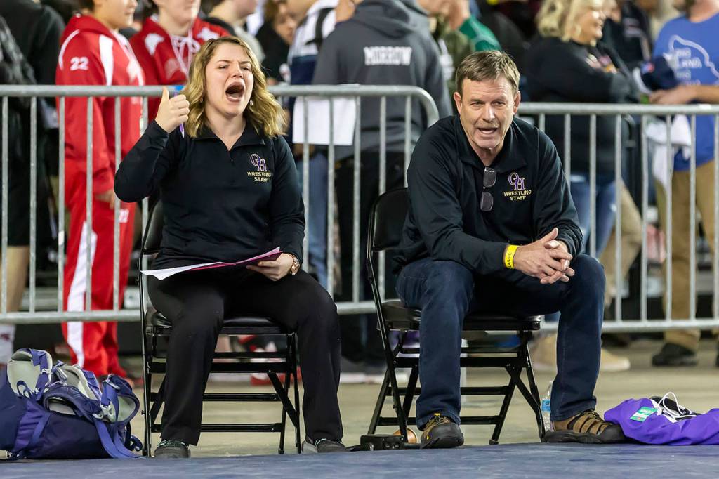 Oak Harbor girls coaches Erin Locke and Brian Farmer encourage Ella Erikson.(Photo by John Fisken)