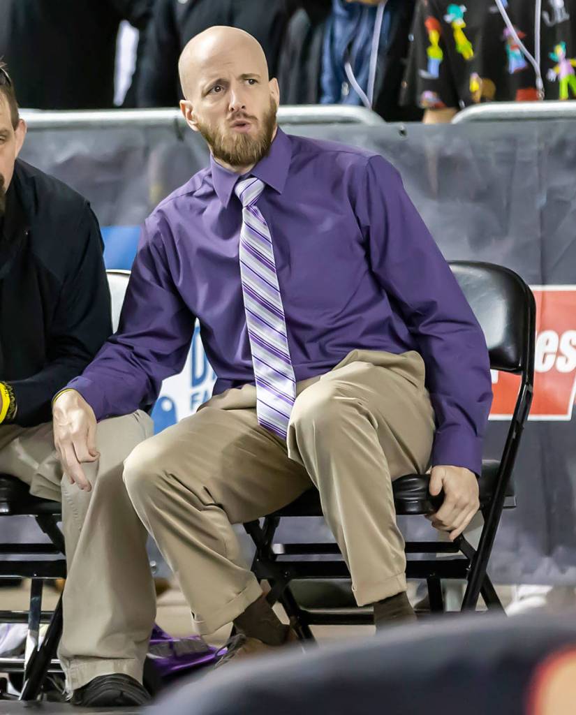 Oak Harbor assistant coach Joe Brannon reacts to what is happening on the mat. (Photo by John Fisken)