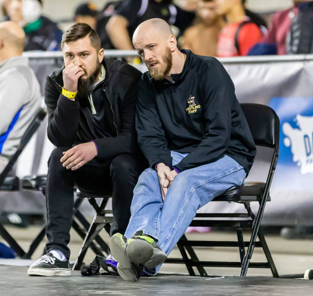 Oak Harbor assisant coaches Cody Fakkema, left, and Joe Brannon are puzzled by what the see at state. (Photo by John Fisken)