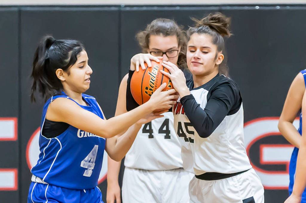 Eighth-graders Kylie Hickam and Allannah Strickland try to gain control.(Photo by John Fisken)