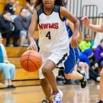Eighth-grader Nerya Rennes hustles the ball up the court.(Photo by John Fisken)
