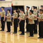 The purple aramed drill team led by student Cmdr. Victor Zarate Jr. performs in the home match Saturday.(Photo by John Fisken)