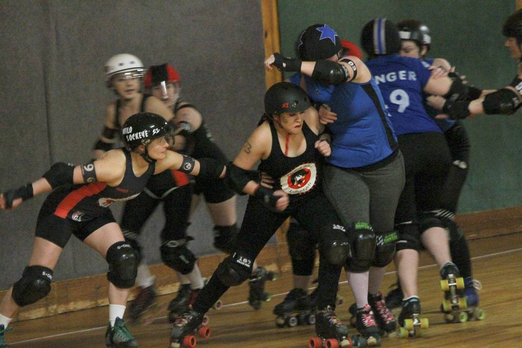 Whitni Schurr (9) and Julie Graystone make it rough on the Doomsday jammer.(Photo by Jim Waller/Whidbey News-Times)