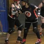 Mary Arthur, left, and Teri Orvis Bravomejia prepare to block in Saturdays bout.(Photo by Jim Waller/Whidbey News-Times)