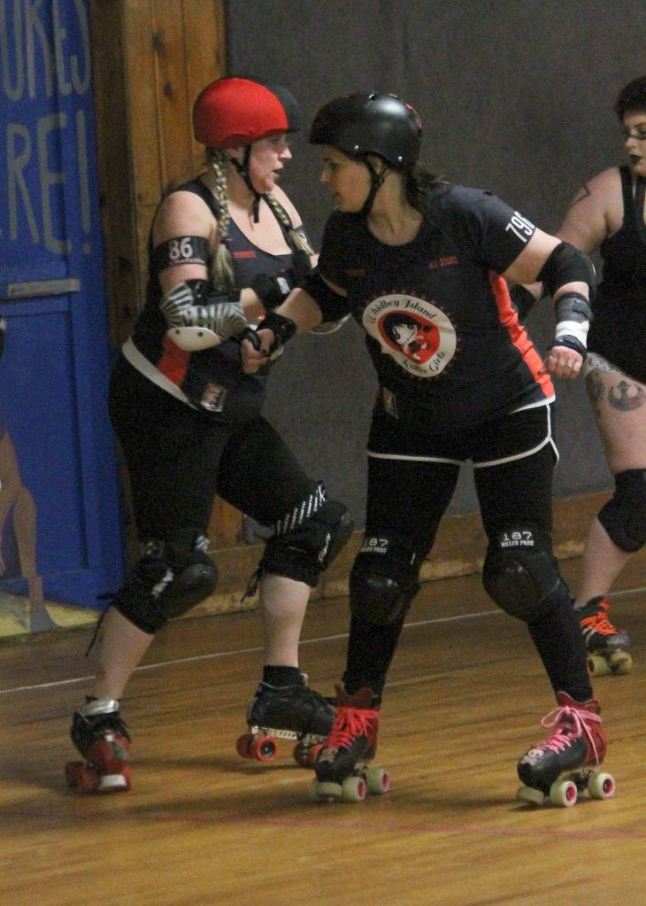 Mary Arthur, left, and Teri Orvis Bravomejia prepare to block in Saturdays bout.(Photo by Jim Waller/Whidbey News-Times)
