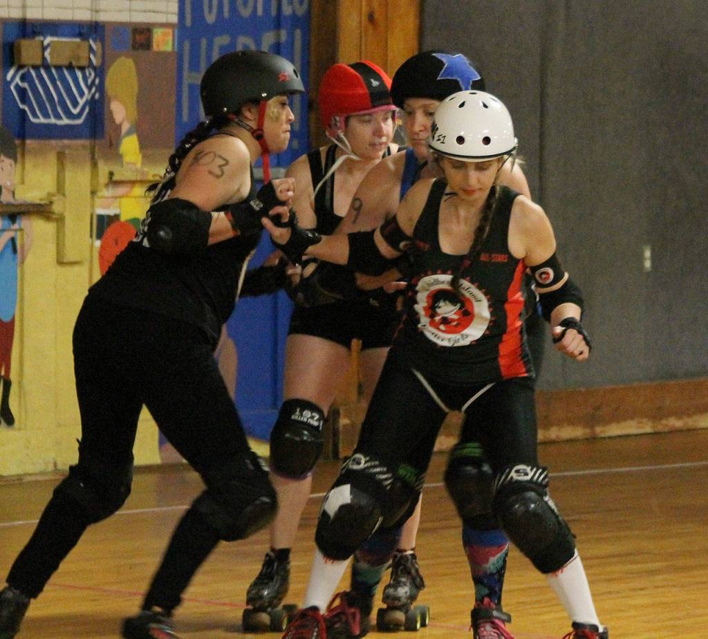 Julie Graystone, Sara Constantine and Chrysalis Kendall bottle up the Bunnies jammer.(Photo by Jim Waller/Whidbey News-Times)