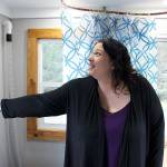 Amber Truex, program manager at Ryans House for Youth, turns flips on the lights in a micro-home donated to the youth organization by the Oak Harbor High School robotics team. (Photo by Laura Guido/Whidbey News Group)