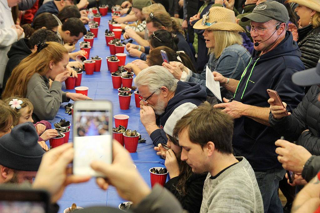 Rawle Jefferds of Penn Cove Shellfish made sure participants ate every last mussel before they could claim the crown. (Photo by Maria Matson/Whidbey News -Times)