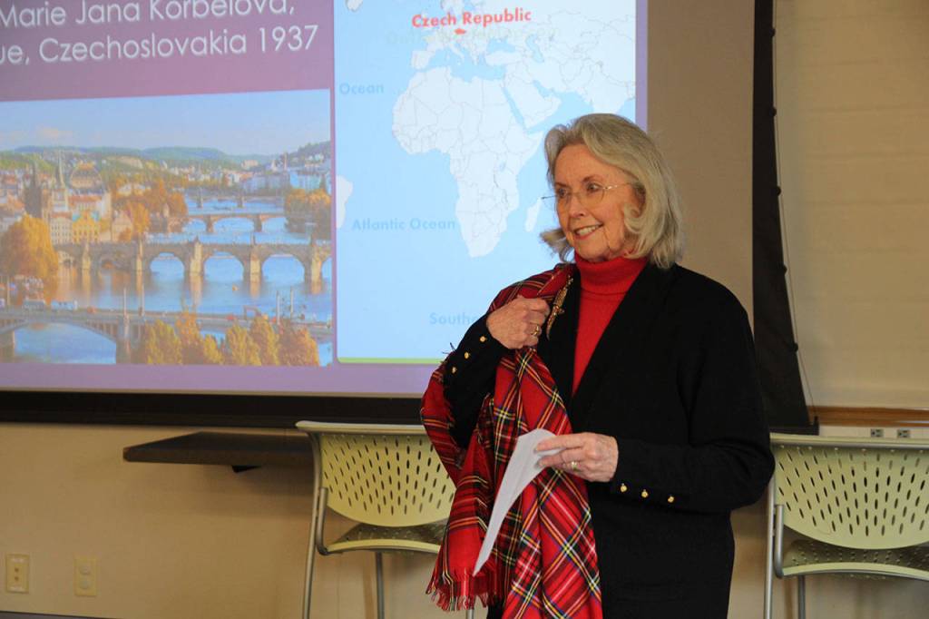 Shirley Bennett, here portraying former Secretary of State Madeleine Albright, shows off her pin. Albright is known for her trademark pin collection and has written a book titled, Read My Pins: The Madeleine Albright Collection, Bennett explained.                                (Photo by Maria Matson/Whidbey News-Times)