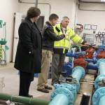 Coupeville Mayor Molly Hughes, Naval Air Station Whidbey Island commander Capt. Matt Arny, and town Utility Superintendent Joe Grogan discuss how a new water filtration system will work with the existing process. Photo by Laura Guido/Whidbey News-Times