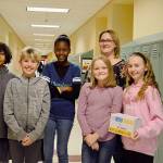 From left, fifth graders Riley Jackson, Grady Anderson, Suki Wardea, Elizabeth Hauter, and Scarlett Nations stand with their leadership teacher Amber Worman at Oak Harbor Intermediate School. The group led an effort to raise more than $8,000 for cancer research to be donated in the name of a staff member. Photo by Laura Guido/Whidbey News-Times