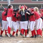 Coupevilles Veronica Crownover (14) is mobbed by the Wolves after hitting a three-run home run against Oak Harbor.(Photo by John Fisken)