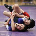 Jadil Estrata, right, goes for the pin.(Photo by John Fisken)