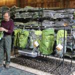 Rich Murphy uses an old barn as a warehouse for a line of backpacks called Aarn that are designed in New Zealand and sold worldwide. Murphy and his wife, Genie, are the new North American distributers for the backpacks that emphasis balance and reducing strain while hiking. (Photo by Patricia Guthrie/Whidbey News Group)                                Rich Murphy shows tandem packs that can attach to backpacks and be worn in front to help with balance. (Photos by Patricia Guthrie/Whidbey News Group)                                The backpacking equipment company called Aarn began when New Zealander founders Aarn Tate and Devi Benson began designing outdoor products to be more body-comfortable. The material is extremely tough but light and durable. The stores balance bags run around $70 to $150 and the full backpacks $200 to $400.