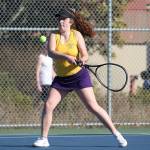 Annie Salinger slaps a backhand in her win in third singles Monday.(Photo by John Fisken)
